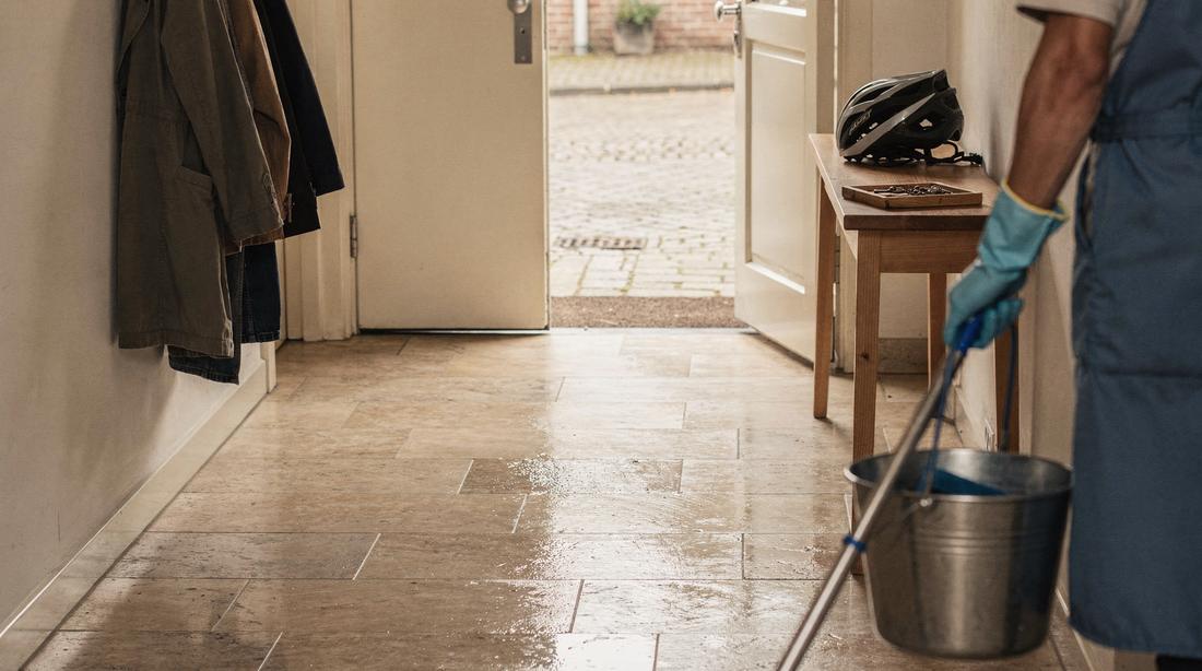 Dutch entrance hall at the end of a routine cleaning visit, the tiled floor freshly mopped