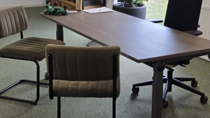 Desks and chairs by an office window