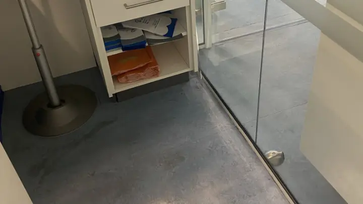 A glass partition over a clean floor