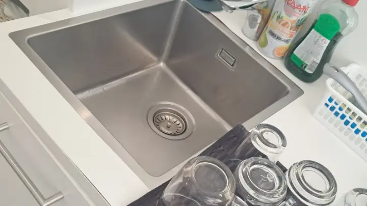 Glasses drying beside a sink