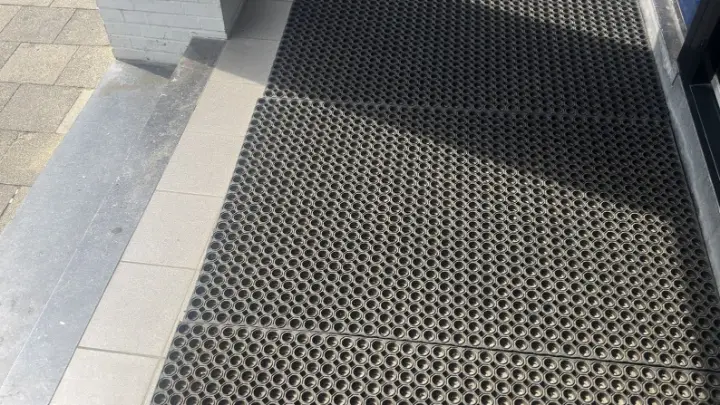 Een roostermat bij de entree van een appartement
