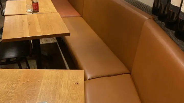 A leather bench along a table