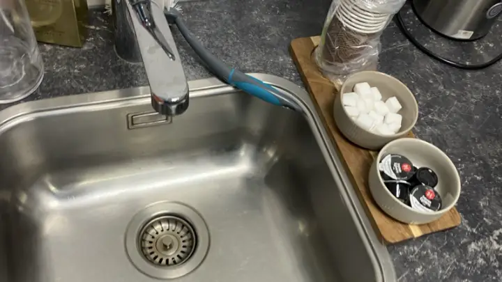 A stainless kitchen sink, close up