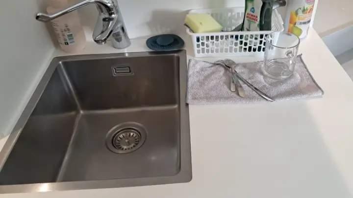 A kitchen sink with a drying rack