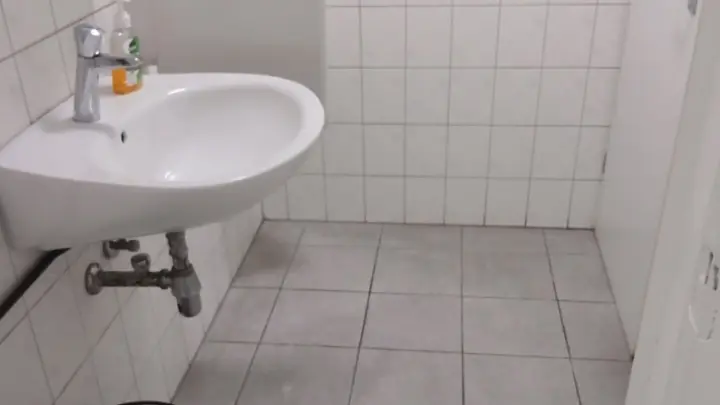 A washbasin in a tiled washroom