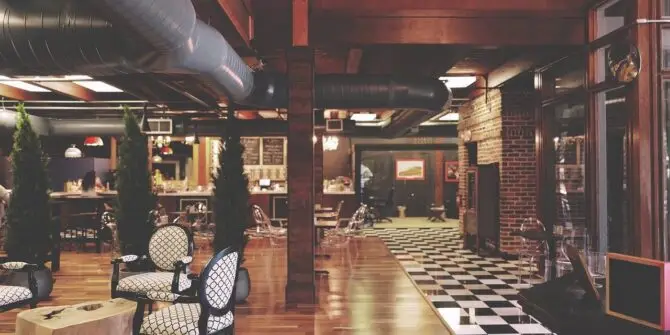 a room with a checkered floor and chairs